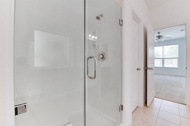 bathroom with tile patterned flooring and a shower with shower door