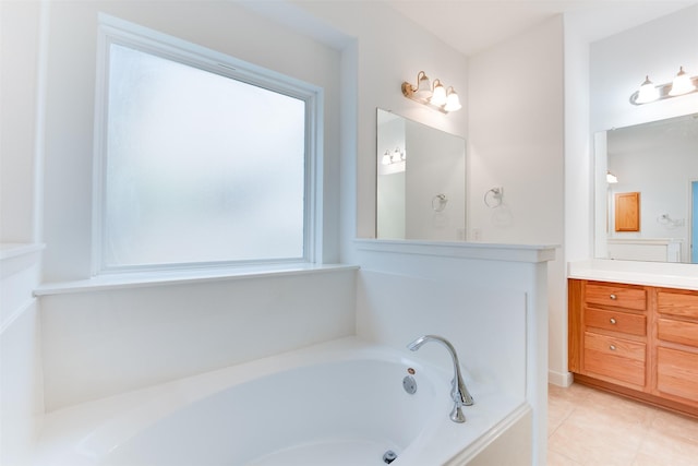 bathroom with vanity, tile patterned flooring, and a bathtub