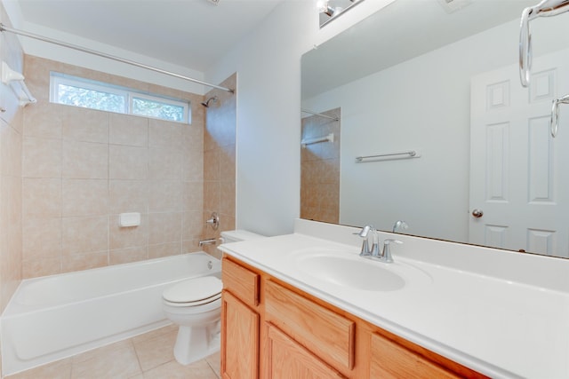 full bathroom featuring vanity, tiled shower / bath combo, tile patterned floors, and toilet