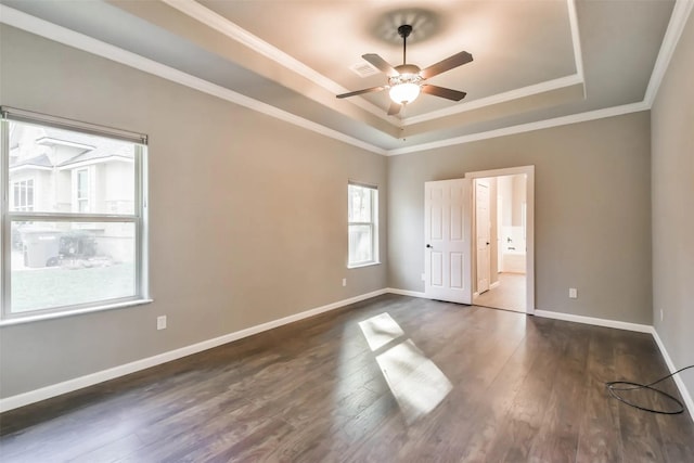 unfurnished bedroom with crown molding, ceiling fan, dark hardwood / wood-style floors, connected bathroom, and a raised ceiling