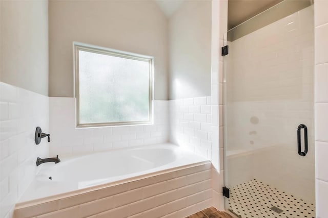 bathroom with shower with separate bathtub