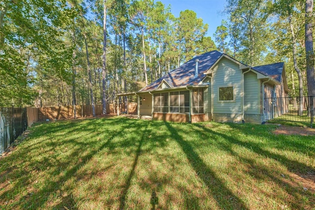 back of property featuring a yard and a sunroom