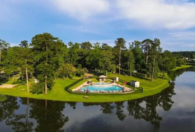 view of property's community with a lawn and a water view