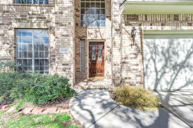 doorway to property with a garage