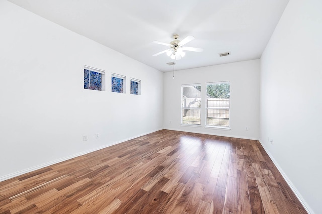 empty room with hardwood / wood-style flooring and ceiling fan