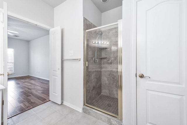 bathroom featuring tile patterned flooring and an enclosed shower