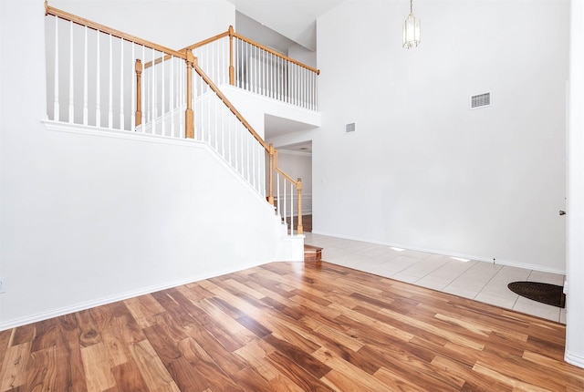 interior space featuring hardwood / wood-style flooring and a high ceiling