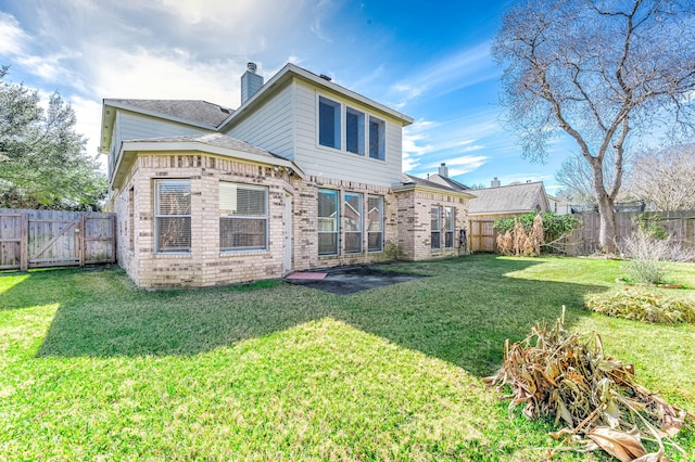 rear view of property featuring a lawn