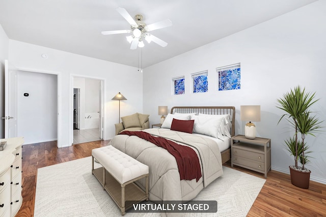 bedroom featuring hardwood / wood-style floors, ceiling fan, and ensuite bathroom