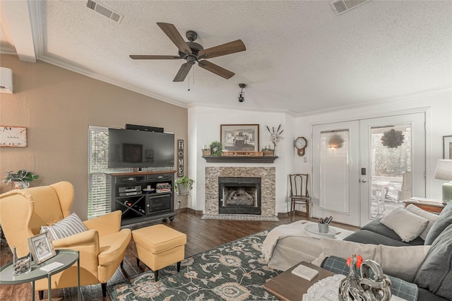 living room featuring wood-type flooring, ornamental molding, french doors, and a textured ceiling