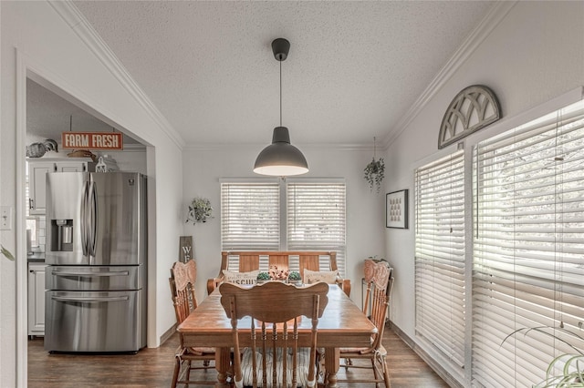 dining room featuring crown molding, dark hardwood / wood-style floors, and a textured ceiling