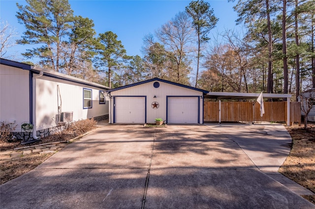 exterior space featuring an outbuilding, a carport, and a garage