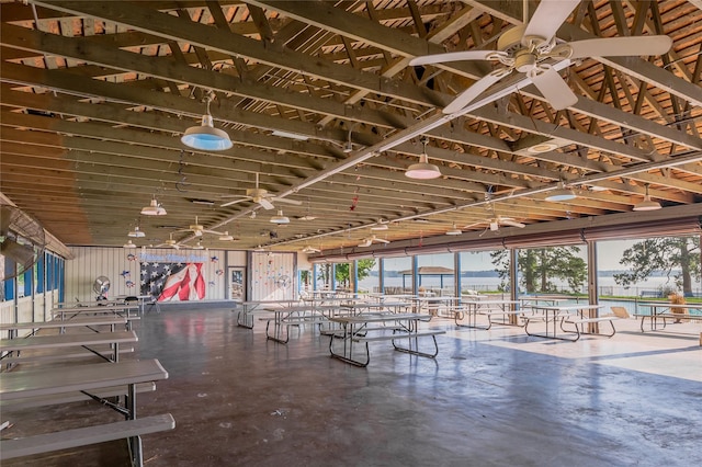 interior space with ceiling fan, concrete flooring, and a wealth of natural light