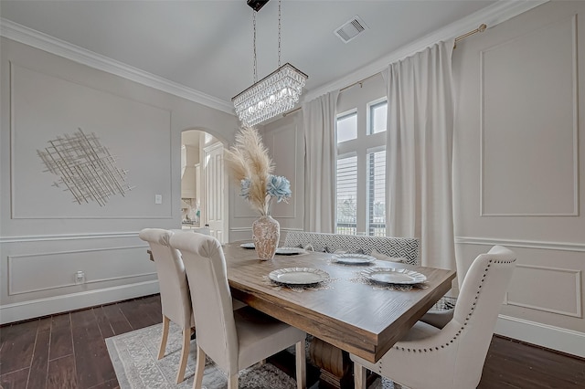 dining room with crown molding and dark wood-type flooring