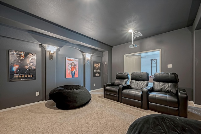 carpeted home theater with ornate columns