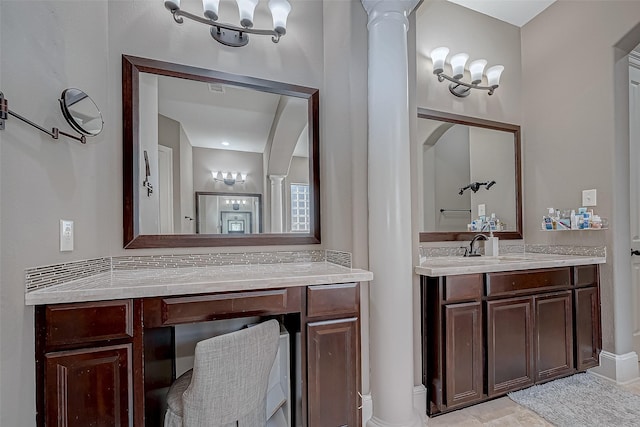 bathroom featuring decorative columns and vanity