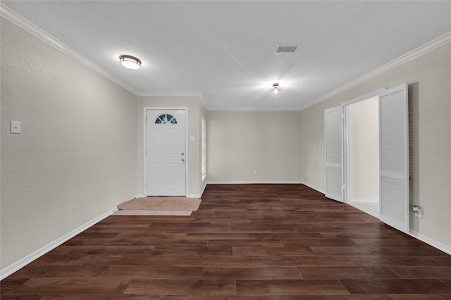 foyer entrance with ornamental molding, a textured ceiling, and dark hardwood / wood-style flooring