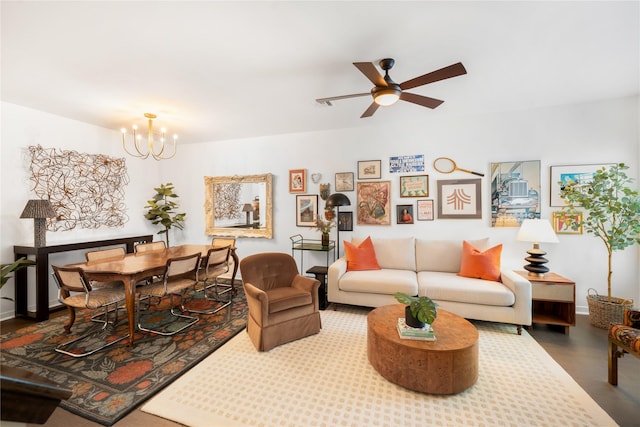 living room featuring hardwood / wood-style floors and ceiling fan with notable chandelier