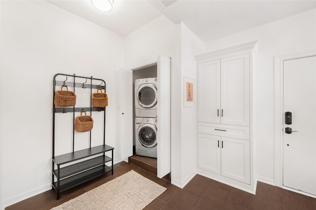 laundry area with stacked washer / dryer and dark hardwood / wood-style floors