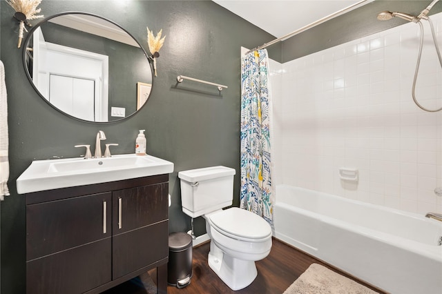 full bathroom featuring hardwood / wood-style flooring, shower / bathtub combination with curtain, vanity, and toilet