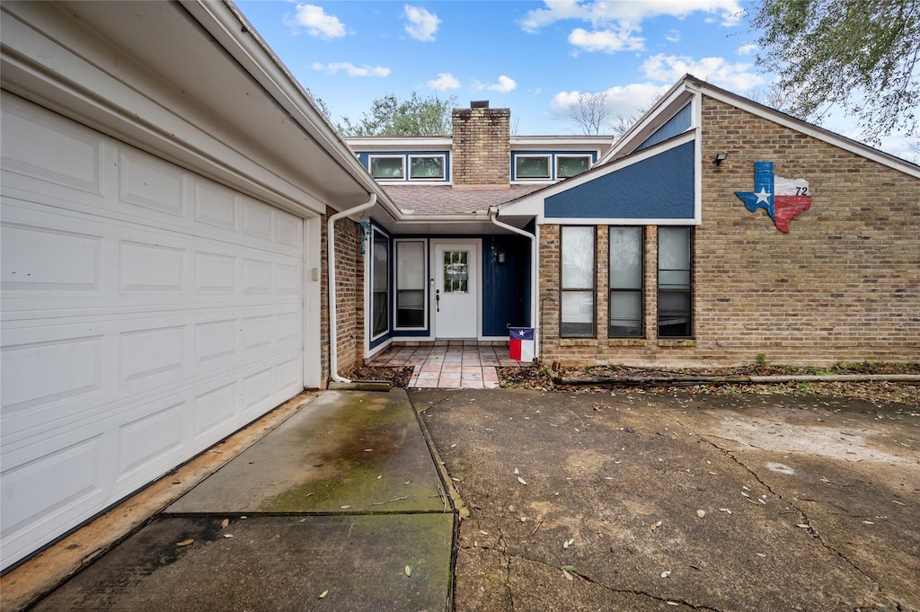 doorway to property featuring a garage