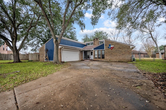 view of front of home with a garage and a front lawn