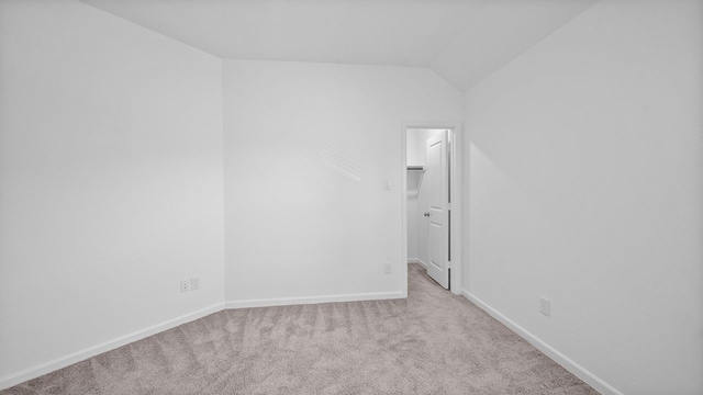 214 Fulton Station Dr, Houston, TX 77009 - spare room featuring carpet, lofted ceiling, and baseboards