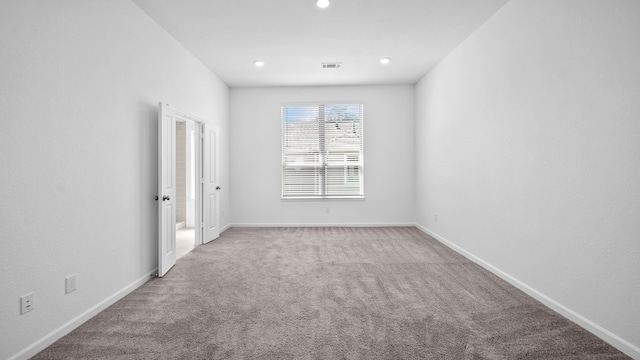 214 Fulton Station Dr, Houston, TX 77009 - carpeted spare room with baseboards, visible vents, and recessed lighting