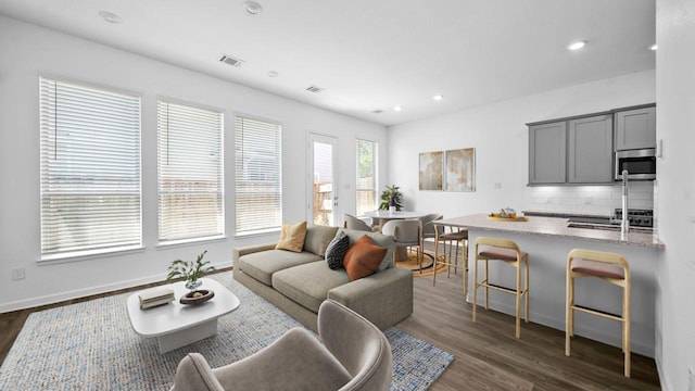214 Fulton Station Dr, Houston, TX 77009 - living room with baseboards, dark wood-style flooring, visible vents, and recessed lighting