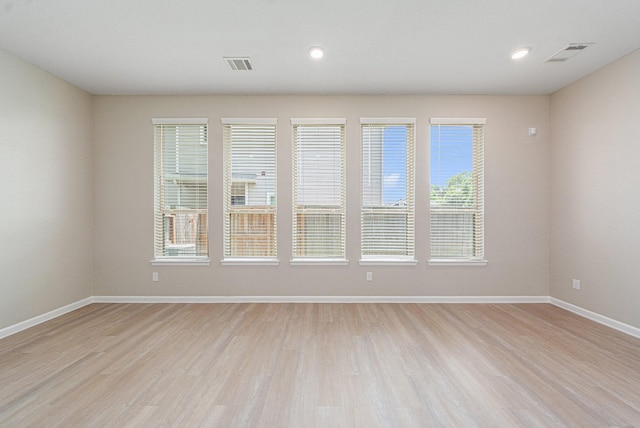 empty room with light hardwood / wood-style floors