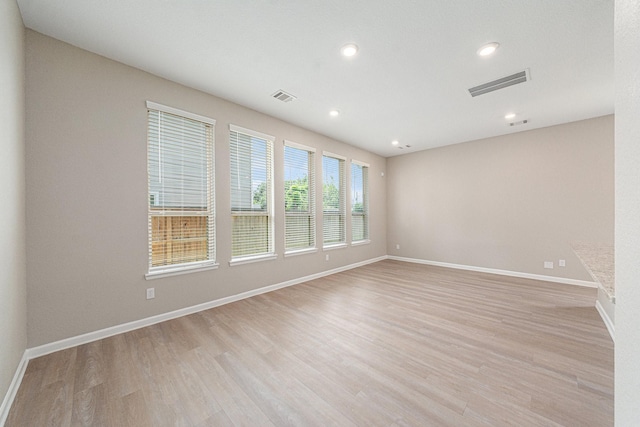 unfurnished room featuring light hardwood / wood-style floors