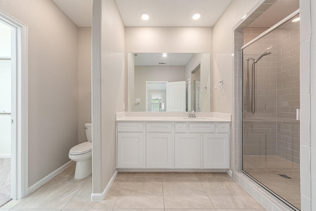 bathroom featuring vanity, tile patterned flooring, a shower with door, and toilet