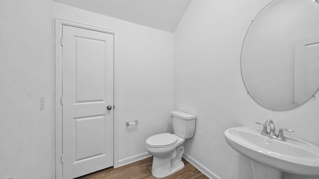 bathroom featuring hardwood / wood-style flooring, sink, and toilet