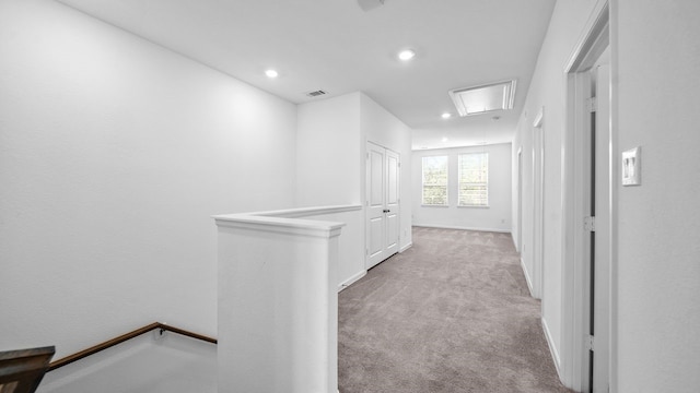 hallway featuring light colored carpet