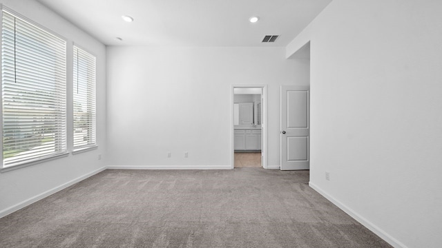 empty room featuring light carpet