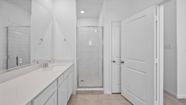 bathroom with vanity, tile patterned flooring, and a shower with door