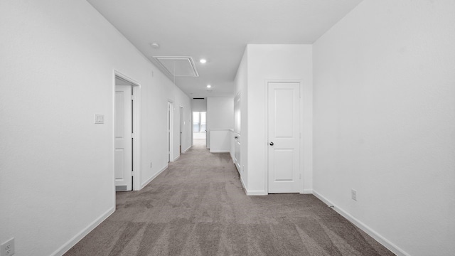 hall with light colored carpet