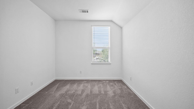 interior space featuring lofted ceiling and carpet flooring