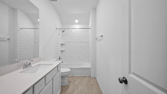 full bathroom with tiled shower / bath, vanity, and toilet