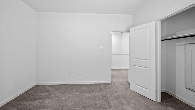 unfurnished bedroom featuring light colored carpet and a closet