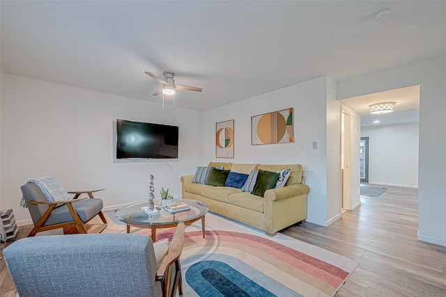 living room featuring ceiling fan and light wood-type flooring