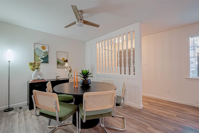 dining space with ceiling fan and light hardwood / wood-style floors