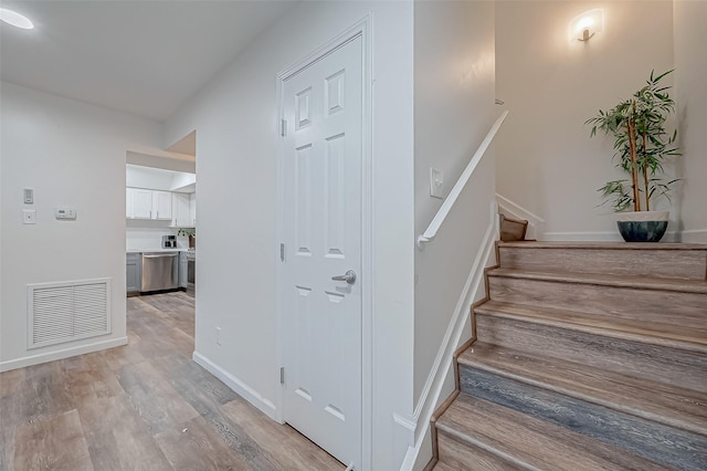 staircase with wood-type flooring