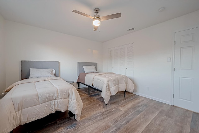 bedroom featuring a closet, ceiling fan, and light hardwood / wood-style flooring