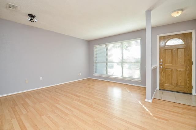 foyer entrance with light hardwood / wood-style flooring