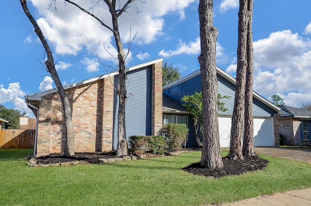 view of side of property featuring a yard and a garage