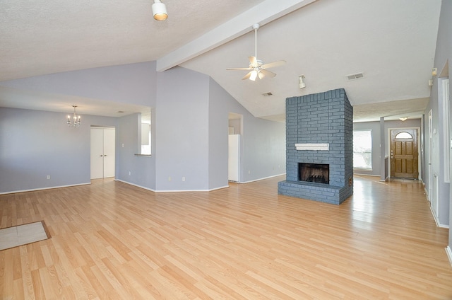 unfurnished living room featuring light hardwood / wood-style flooring, ceiling fan with notable chandelier, a fireplace, and beamed ceiling