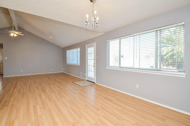 foyer entrance featuring ceiling fan with notable chandelier, light hardwood / wood-style floors, and vaulted ceiling with beams