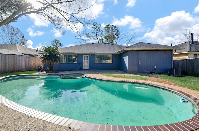 view of pool with central AC and an in ground hot tub