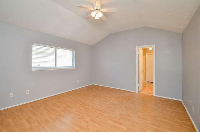 spare room with ceiling fan, lofted ceiling, light hardwood / wood-style flooring, and a textured ceiling